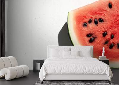 a sliced watermelon with a vibrant red interior and black seeds against an isolated white background Wall mural