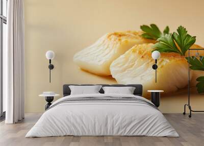 a smoked haddock fillet with a golden hue and a sprig of parsley against an isolated warm-toned background Wall mural