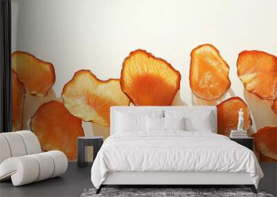 dried persimmon slices: a frame made from dried persimmon slices, scattered naturally across a light cream background, the bright orange tones of the fruit create a lively, autumnal atmosphere Wall mural