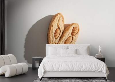 two biscotti with visible almonds and a crunchy texture against an isolated white background Wall mural