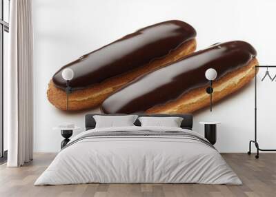 two eclair with glossy chocolate glaze and creamy filling visible at the ends against an isolated white background Wall mural