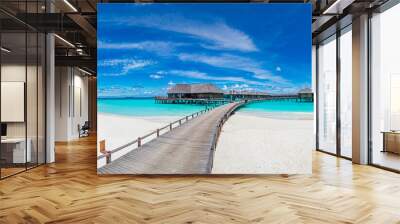 Amazing beach panorama at Maldives. Luxury resort villas seascape with paradise island coast. Beautiful blue sky and white clouds. Beautiful beach background for vacation holiday.
 Wall mural