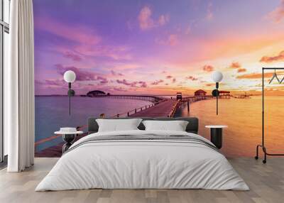 Amazing sunset sunrise sky and reflection on calm sea, Maldives beach landscape of luxury over water villas bungalows. Exotic scenery of summer vacation and holiday background. Tropical seascape sky Wall mural