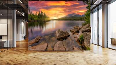 Awesome nature landscape. Beautiful scene with high Tatra mountain peaks, stones in mountain lake, calm lake water, reflection, colorful sunset sky. Amazing nature background. Autumn adventure hiking Wall mural