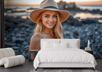 Carefree stylish blonde woman enjoying summer sunset. Beautiful woman wears sexy dress sunset light at beach wearing straw hat. Summertime vacation tourism on rocky shoreline beach. AI generated Wall mural