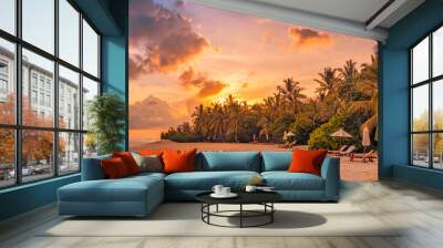 Fantastic panoramic view. Sandy shore with orange sunrise sunset sunlight over chairs palm trees. Tropical island beach landscape, exotic coast. Summer vacation, holiday amazing nature. Relax panorama Wall mural