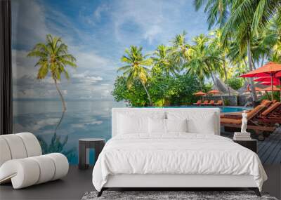 Happy tourism holiday landscape. Luxury beach resort hotel swimming pool, leisure beach chairs under umbrellas palm trees, blue sunny sky. Summer island seaside, relax mood travel vacation background Wall mural