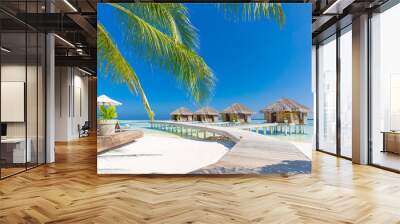 Maldives luxury water villas over white sand, blue sky. Amazing summer vacation travel destination, tropical landscape. Luxurious Maldives island landscape Wall mural