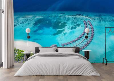 Perfect aerial landscape, luxury tropical resort or hotel with water villas and beautiful beach scenery. Amazing bird eyes view in Maldives, landscape seascape aerial view over a Maldives Wall mural