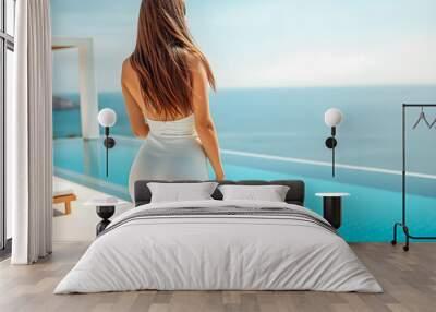 Sensual sexy view from behind on fit woman with long brown hair in a long tight dress looking on the infinity pool and beautiful sea. Summer vacation concept design. Summer travel tourism pattern. AI Wall mural