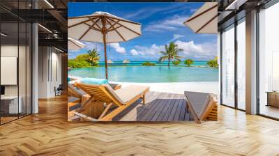 Summer beach vacation pool. Chaise lounge concept, luxury travel. Infinity oceanfront pool with submerged loungers in a luxury resort in Maldives, Indian Ocean Wall mural