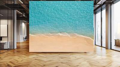 Summer seascape beautiful waves, blue sea water in sunny day. Top view from drone. Sea aerial view, amazing tropical nature background. Beautiful bright sea waves splashing and beach sand sunset light Wall mural