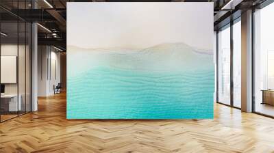 Summer seascape beautiful waves, blue sea water in sunny day. Top view from drone. Sea aerial view, amazing tropical nature background. Beautiful bright sea with waves splashing and beach sand concept Wall mural