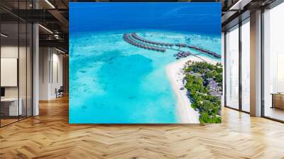 The drone photo with a wooden water villas seen from above and an amazing blue lagoon crystal clear water close to tropical lagoon. Amazing summer travel and vacation background. Dreamy beach scenery Wall mural