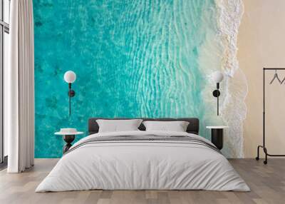 Top view on coast waves on beach aerial view, crystal clear water. Stunning summer landscape, sunny tropical island shore. Seaside, idyllic nature Earth view. Stunning scenery, amazing view Wall mural