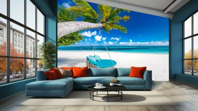 Tropical beach background as summer landscape with beach swing or hammock and white sand and calm sea for beach banner. Perfect beach scene vacation and summer holiday concept. Boost up color process Wall mural