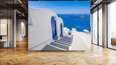 White wash staircases on Santorini Island, Greece. The view toward Caldera sea with speedboat passing. Luxury summer destination scenic, blue doors, tranquil honeymoon background. Caldera Aegean sea Wall mural