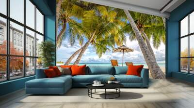 Wonderful beach scenery, palms and sun beds with sea view. Tropical beach landscape as summer vacation and holiday resort template Wall mural