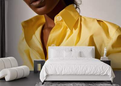 A contemporary African fashion model in a vibrant yellow blouse, exuding confidence and style.  Wall mural