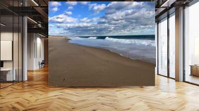 Beautiful empty sand beach with surfer waves and a blue sky with white clouds in Charlestown, Rhode Island (United States of America) Wall mural