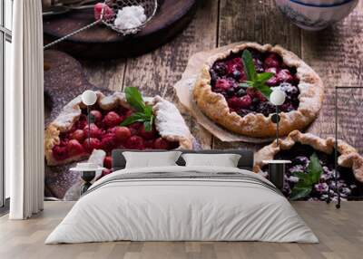 Blueberry,cherry,raspberry and blackcurrant galette on w wooden background. Wall mural