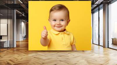 a toddler giving a thumbs up on yellow background Wall mural