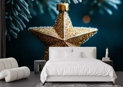 Close-up of a gold star ornament hanging on a frosted Christmas tree branch with soft glowing lights holiday decoration Wall mural