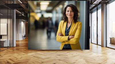 Portrait of successful business woman inside office, standing with arms crossed Wall mural