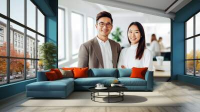 portrait of two young asian business people standing in the office Wall mural