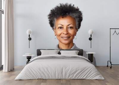 studio portrait of stylish middle age smiling 50 - 55 year old woman posing on grey background Wall mural