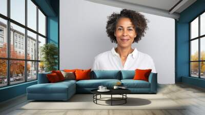 studio portrait of stylish middle age smiling 50 - 55 year old woman posing on grey background Wall mural