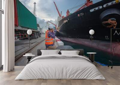 Stevedore forman, supervisor, harbour master, port captain working in charge of command in loading discharging containers shipment operation,  at port terminal Wall mural