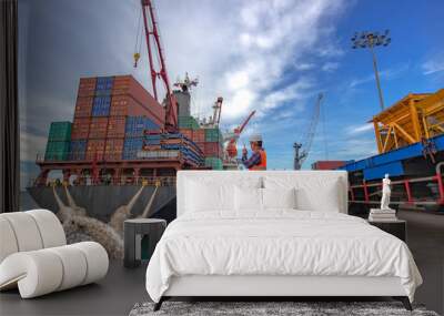 the loading and discharging operation container ship vessel in port takes control by stevedore and foreman in charge, working in port terminal being for logistics and transport services to worldwide. Wall mural