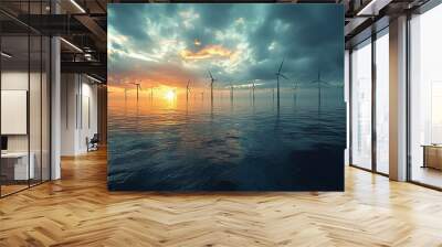 A line of wind turbines stand in the ocean at sunset. Wall mural