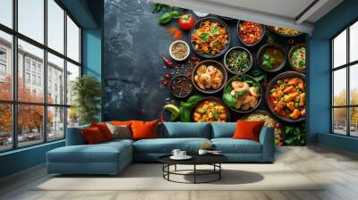 A variety of Asian cuisine dishes served on black bowls arranged on a dark background, with ingredients such as shrimp, vegetables, and sauces. Wall mural