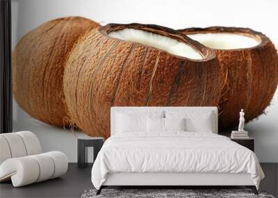 Two coconuts, one whole and one cracked open, revealing the white flesh inside. Wall mural