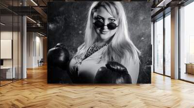 Attractive plump woman with boxing gloves studio portrait. Wall mural