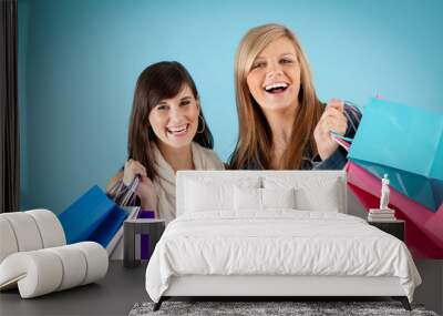 Happy Young Women Holding Shopping Bags - Isolated on Blue Wall mural