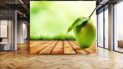 Raw mango single on wooden top with nature background Wall mural