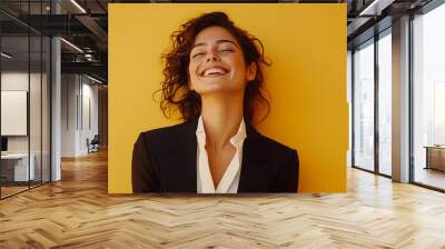 Happy young business woman posing isolated on yellow background Wall mural