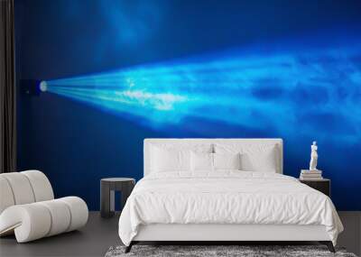 A blue light is shining on a wall Wall mural