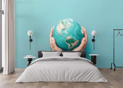 A person is holding a globe in their hands Wall mural