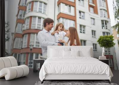 Happy family in front of new apartment building Wall mural