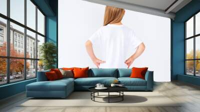 little girl in brand new white blank t shirt on white background with copy space, back view Wall mural