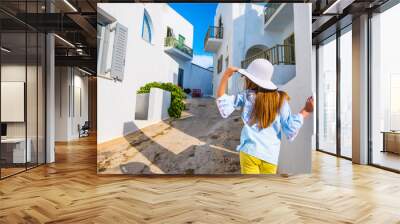 Little girl in white hat on a greek street Wall mural