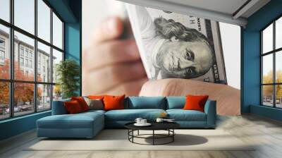 Man counting american dollars banknotes, close up view Wall mural