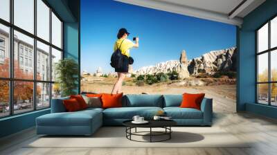 Woman tourist taking pictures of mountains in Cappadocia, Turkey Wall mural