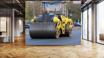 Ukraine, Kharkiv, October 27, 2020. Close-up view on the workers and the asphalting machines. Roller and workers on asphalting and repair of city streets Wall mural