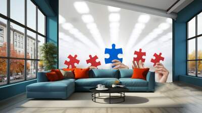 Hand holding puzzle blue and red at factory and warehouse background, collaboration concept. Wall mural