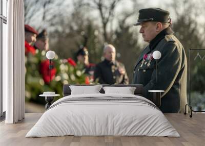 A man in a military uniform participates in a wreath-laying ceremony at a war memorial, surrounded by colorful flowers, A traditional wreath-laying ceremony at a war memorial Wall mural